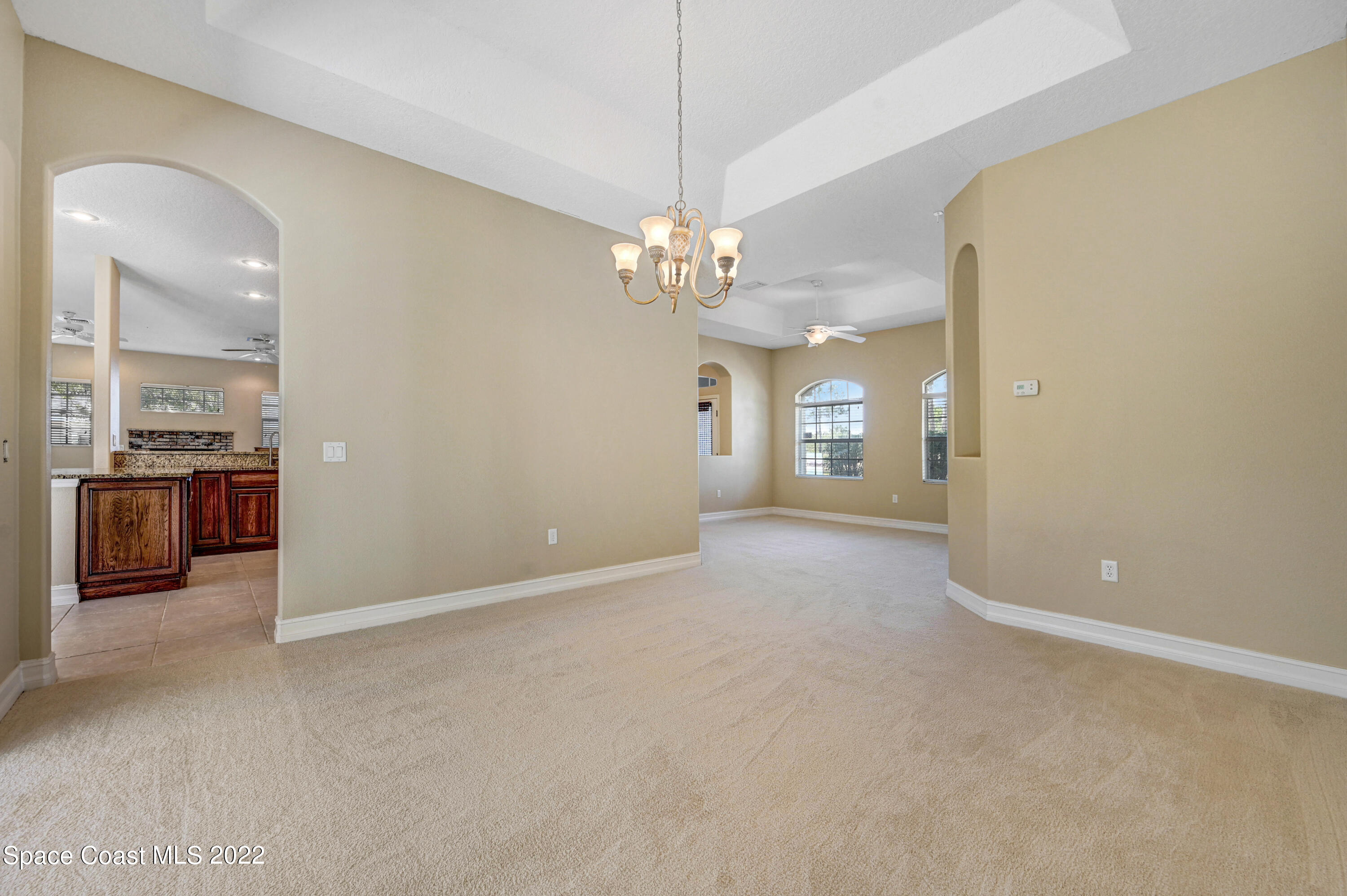 2185 Windbrook Drive Palm Bay, FL 32909 - Photo 31 of 61 a view of a livingroom with a chandelier furniture and windows