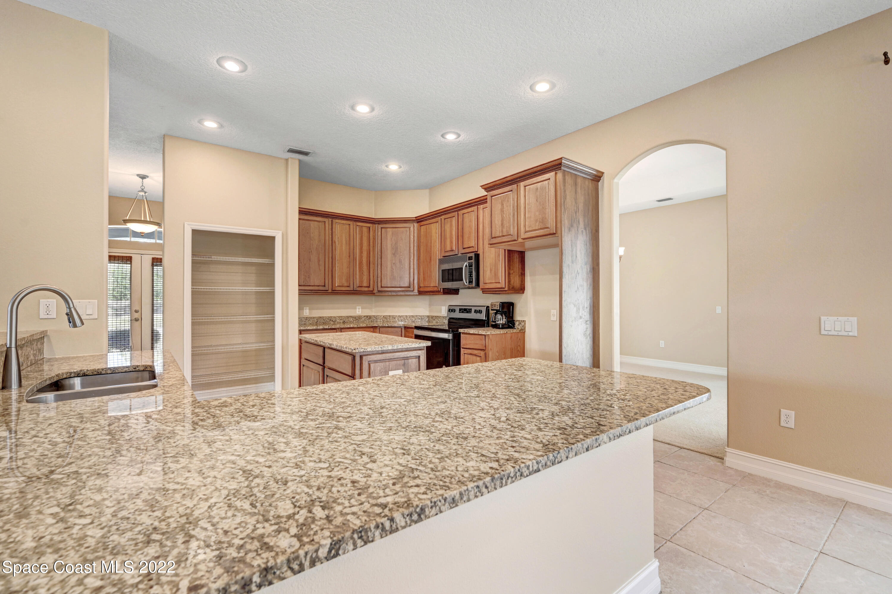 2185 Windbrook Drive Palm Bay, FL 32909 - Photo 35 of 61 a kitchen with stainless steel appliances granite countertop a refrigerator and a sink