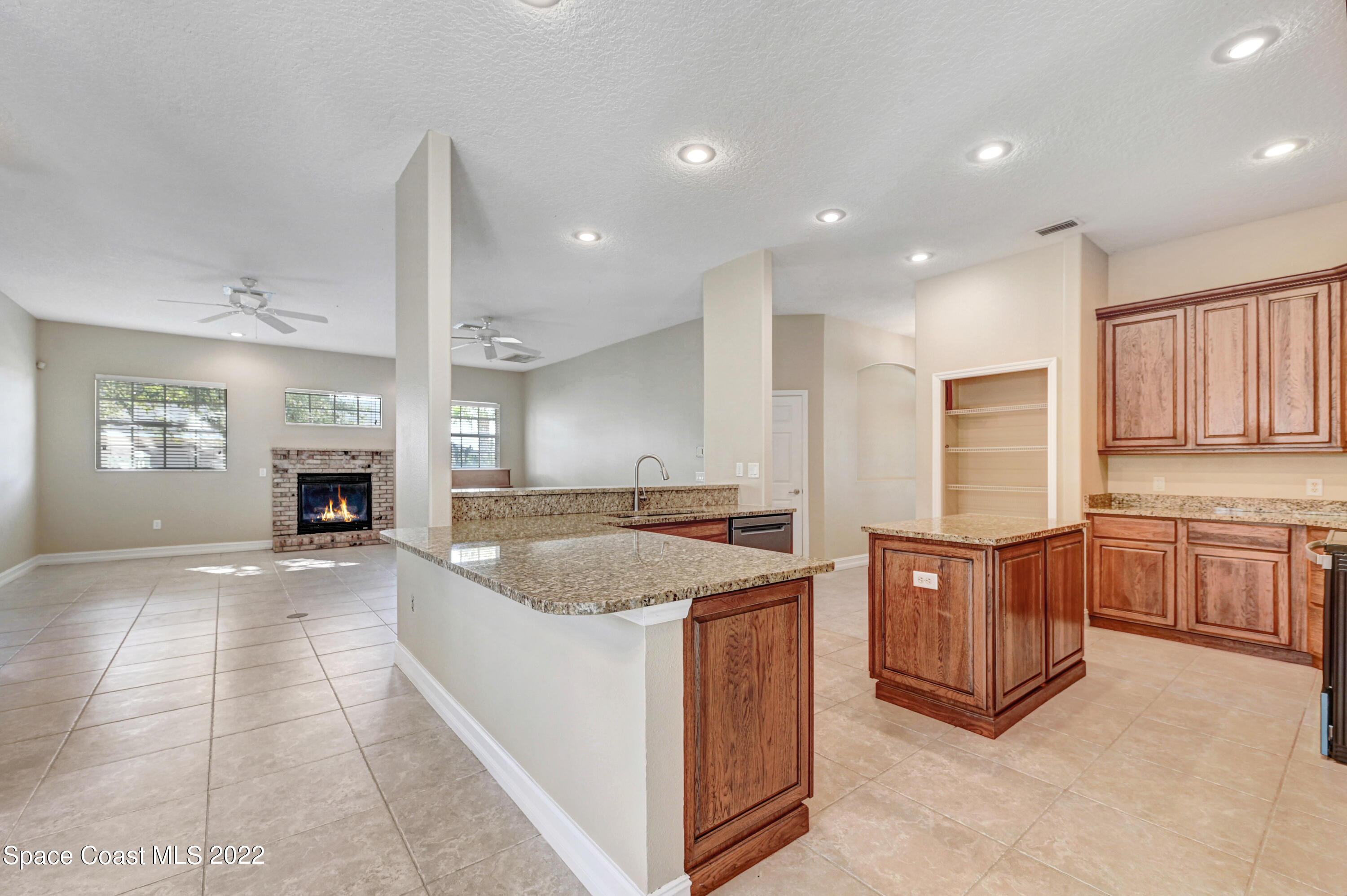 2185 Windbrook Drive Palm Bay, FL 32909 - Photo 36 of 61 a kitchen with stainless steel appliances granite countertop a sink a stove and a refrigerator