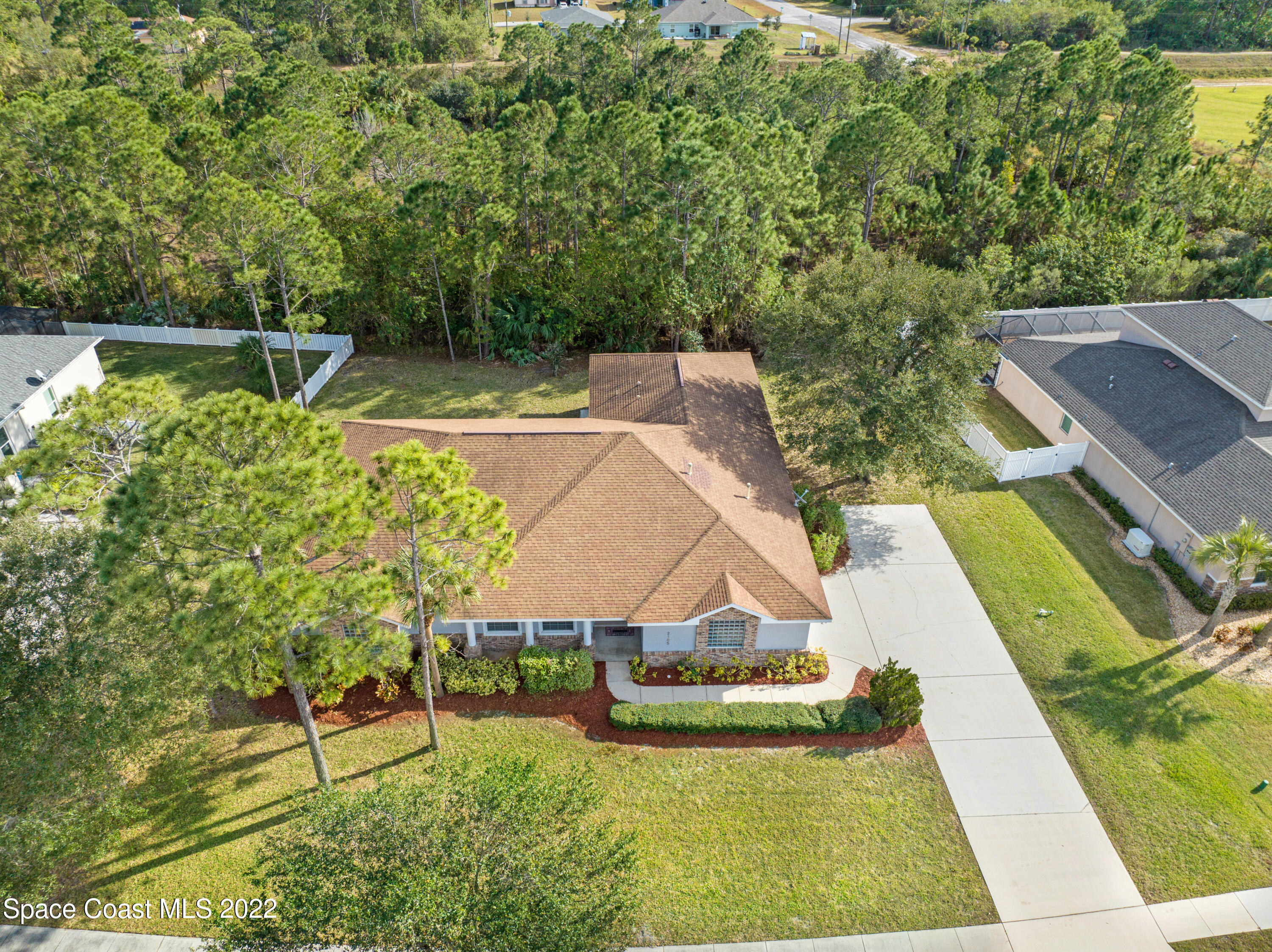 2185 Windbrook Drive Palm Bay, FL 32909 - Photo 4 of 61 an aerial view of a house with swimming pool and tennis court