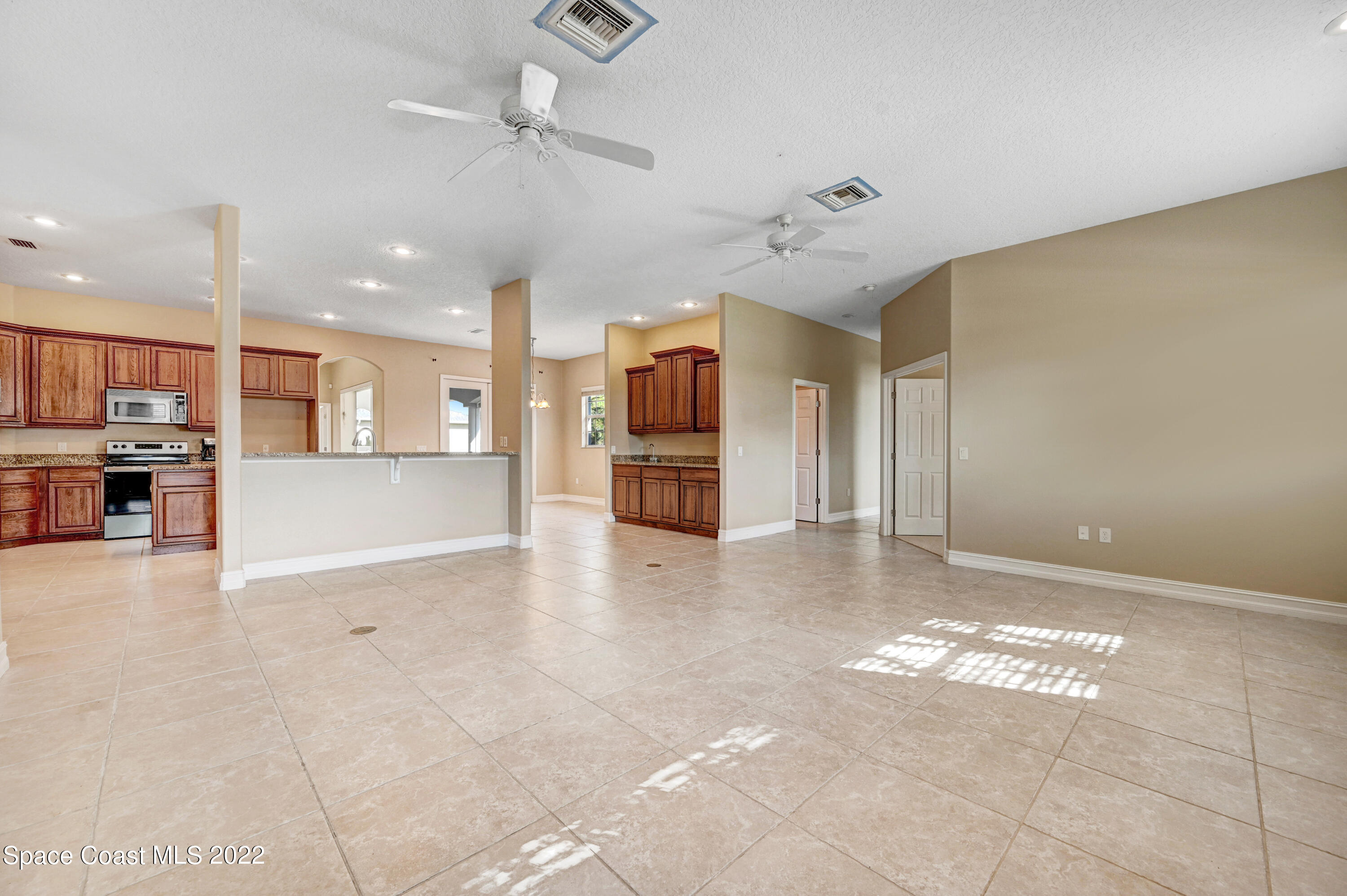 2185 Windbrook Drive Palm Bay, FL 32909 - Photo 41 of 61 a view of a kitchen with a stove and a kitchen island