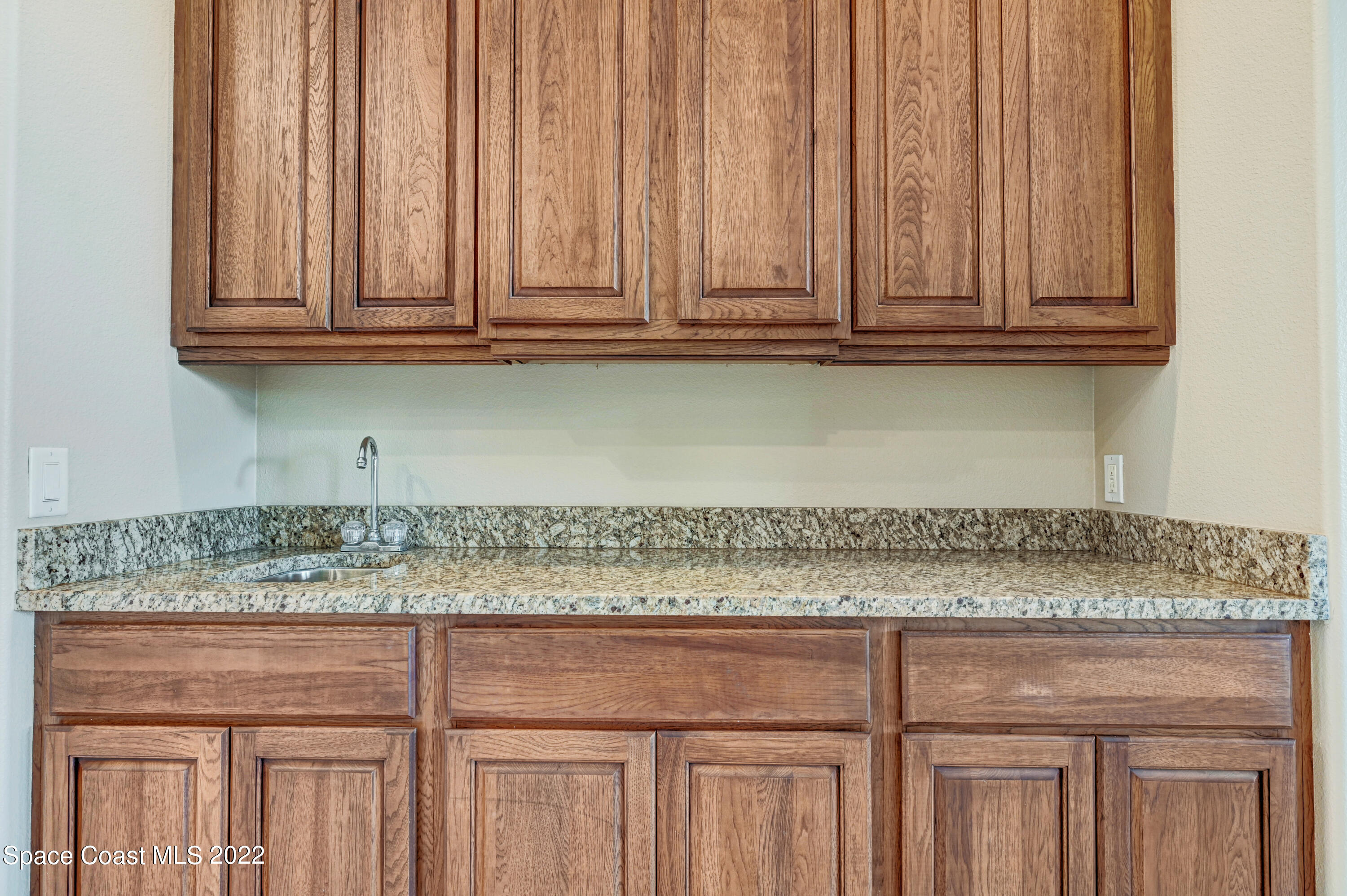 2185 Windbrook Drive Palm Bay, FL 32909 - Photo 44 of 61 a view of granite countertop white cabinets and a wooden floor