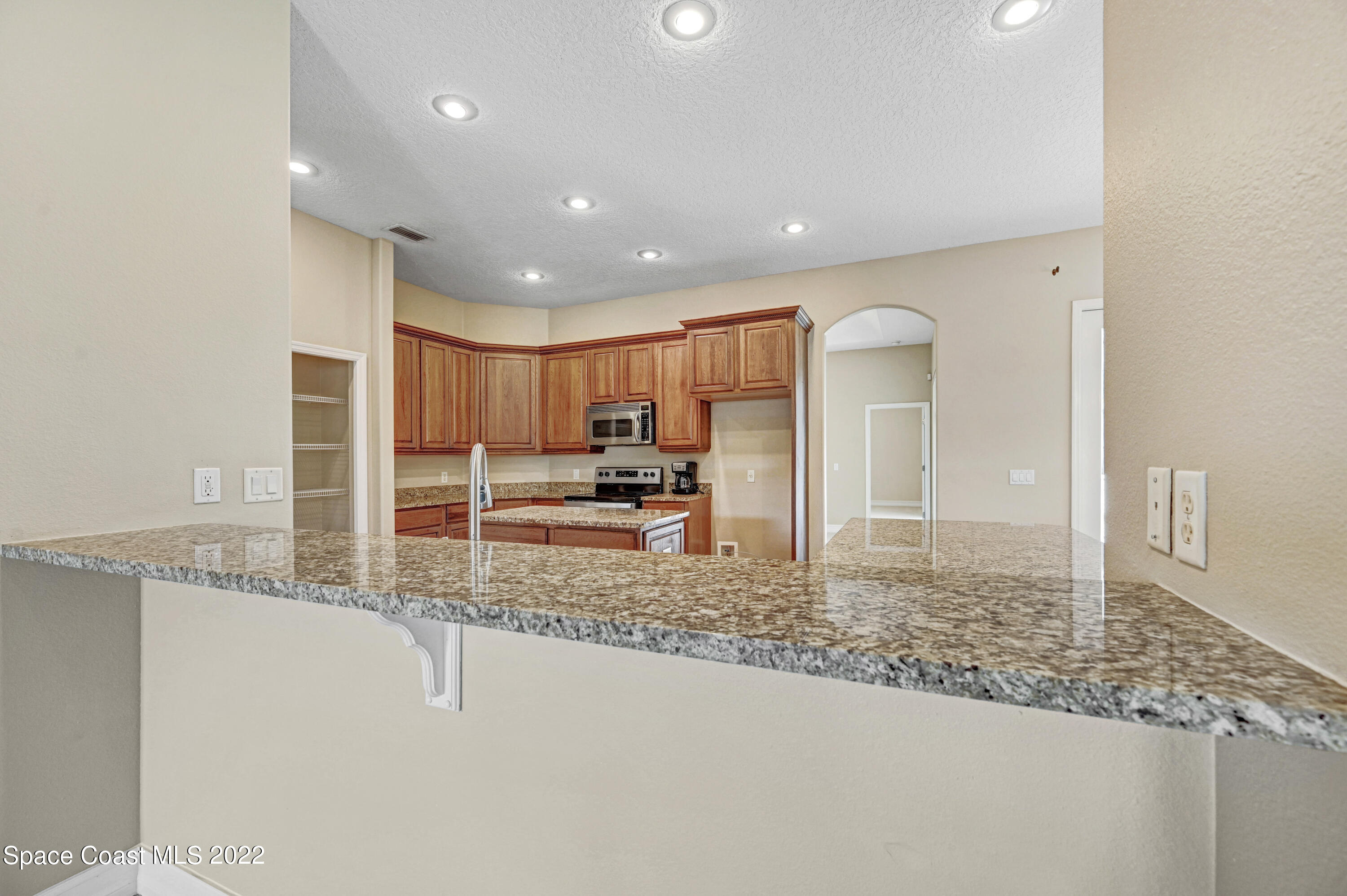 2185 Windbrook Drive Palm Bay, FL 32909 - Photo 45 of 61 a bathroom with a granite countertop sink and a mirror