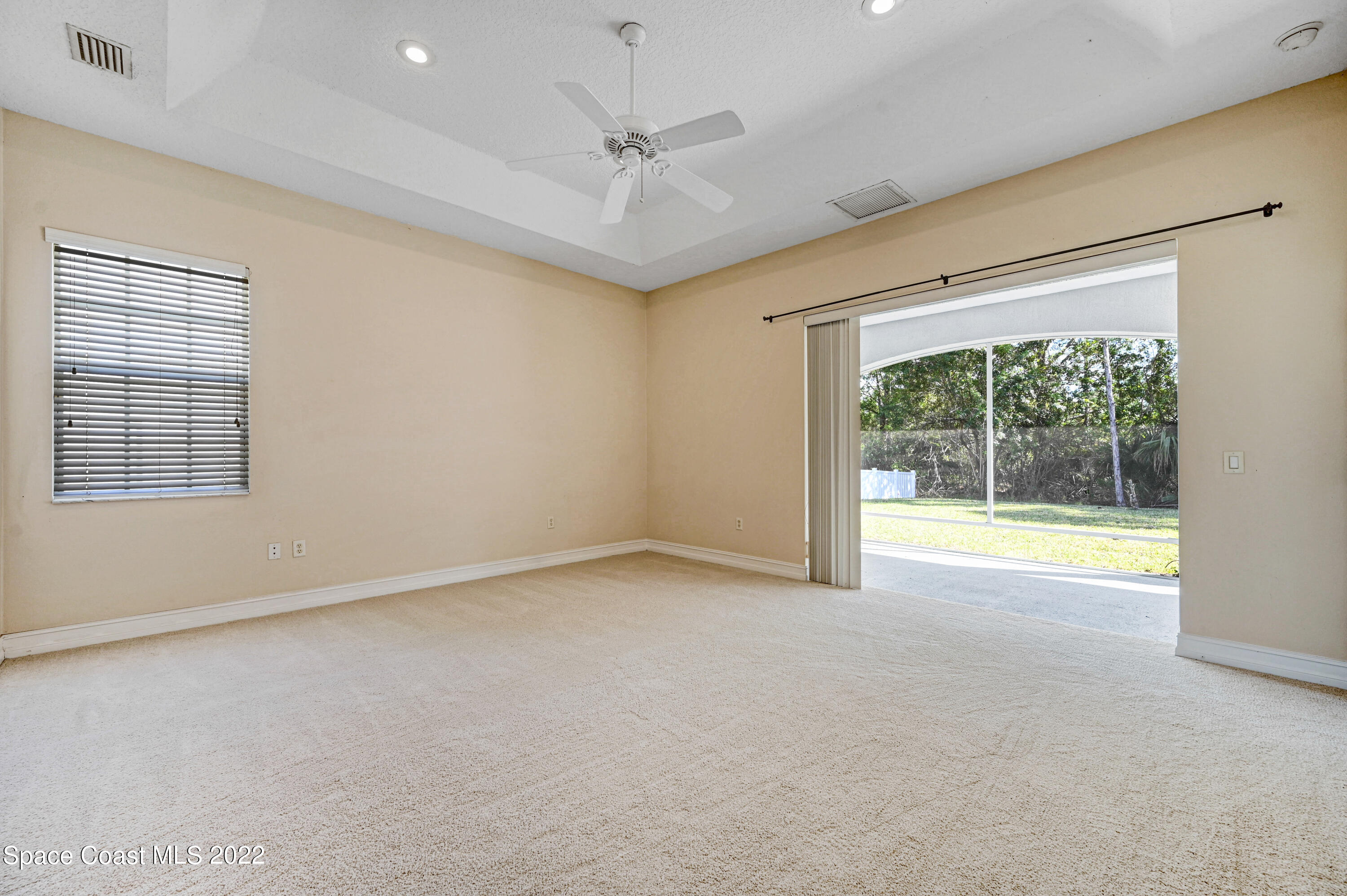 2185 Windbrook Drive Palm Bay, FL 32909 - Photo 47 of 61 an empty room with a large window with a ceiling fan
