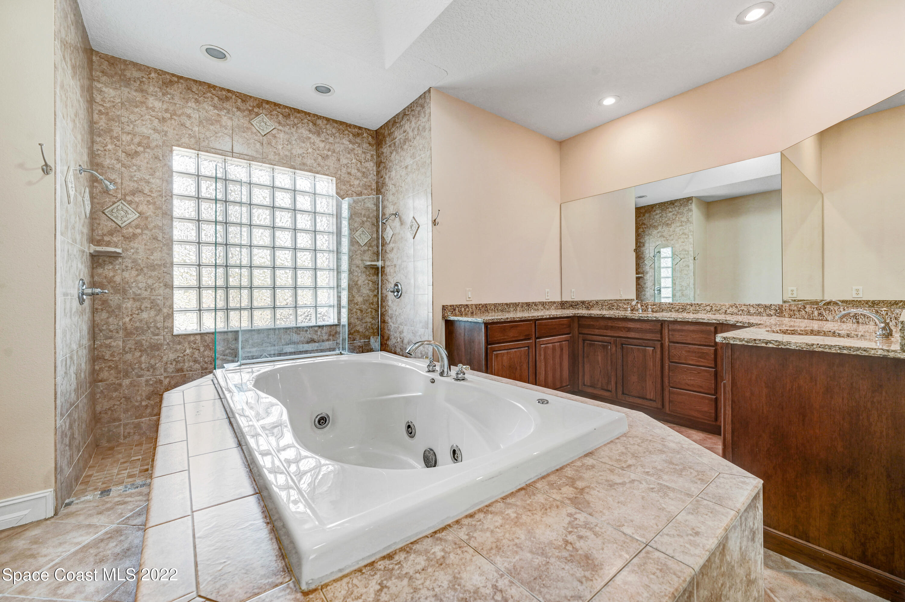 2185 Windbrook Drive Palm Bay, FL 32909 - Photo 49 of 61 a bathroom with a tub sink and mirror