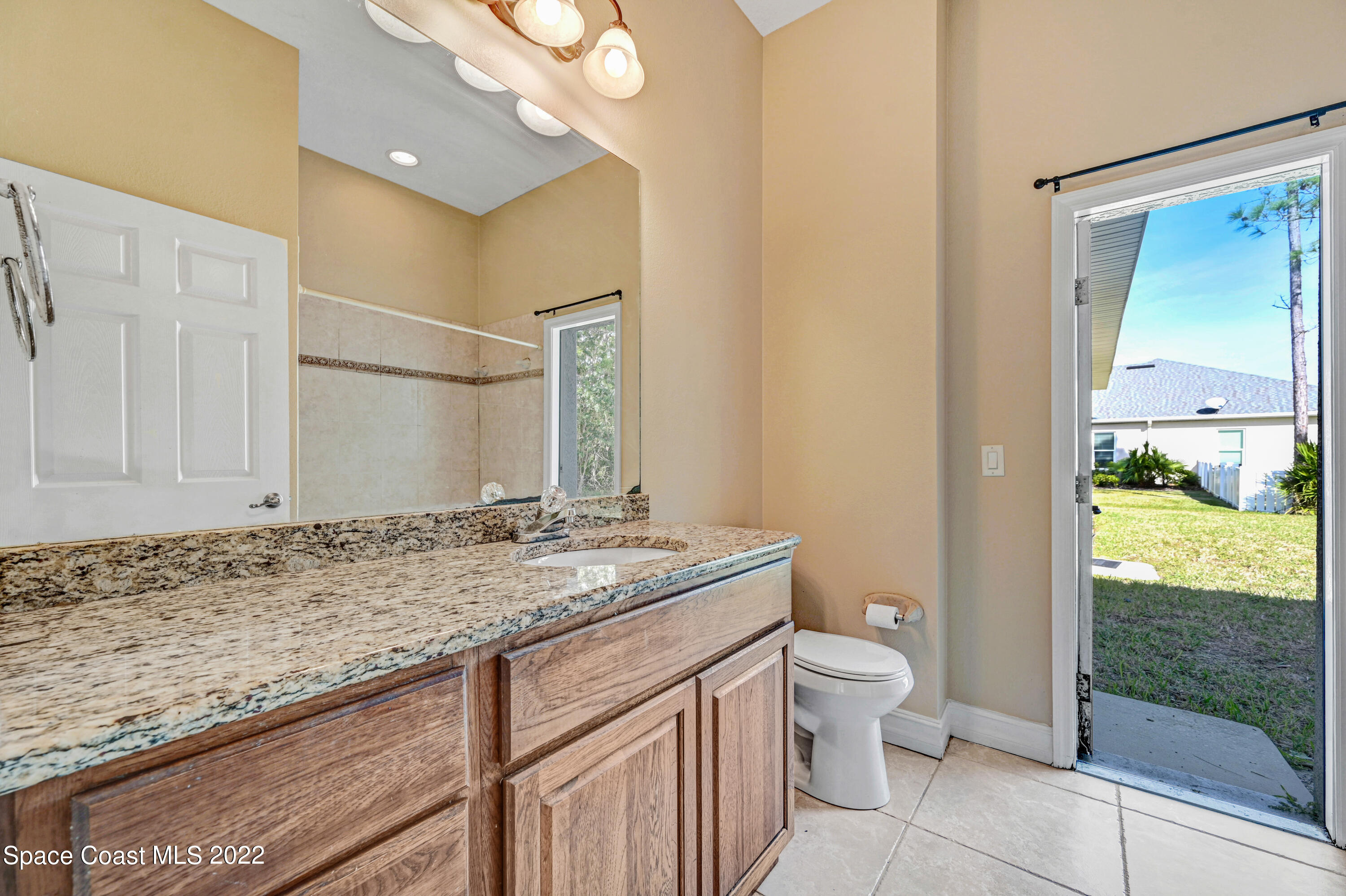 2185 Windbrook Drive Palm Bay, FL 32909 - Photo 56 of 61 a bathroom with a granite countertop sink a toilet and a shower