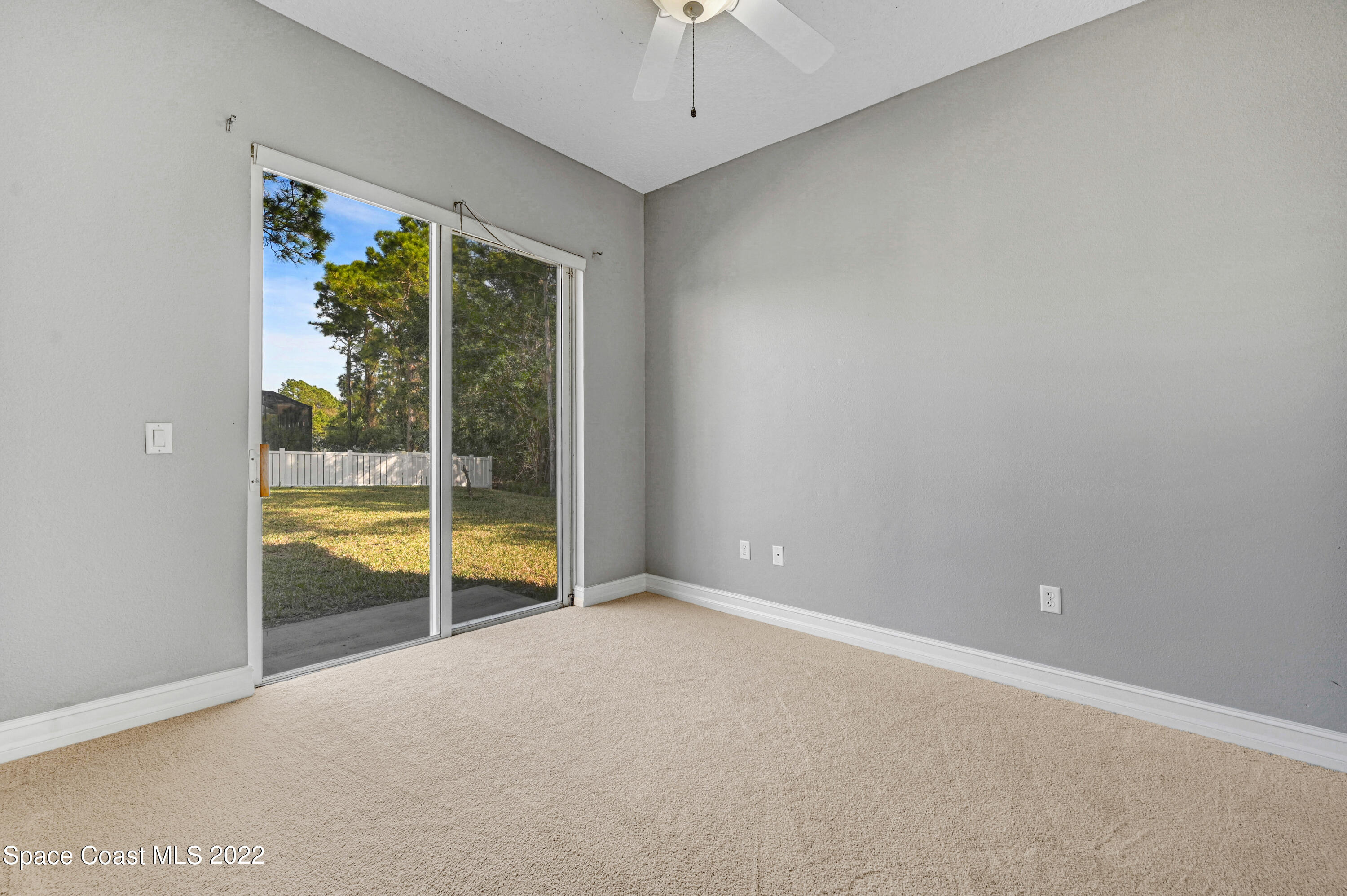 2185 Windbrook Drive Palm Bay, FL 32909 - Photo 59 of 61 an empty room with floor to ceiling window and an outdoor view
