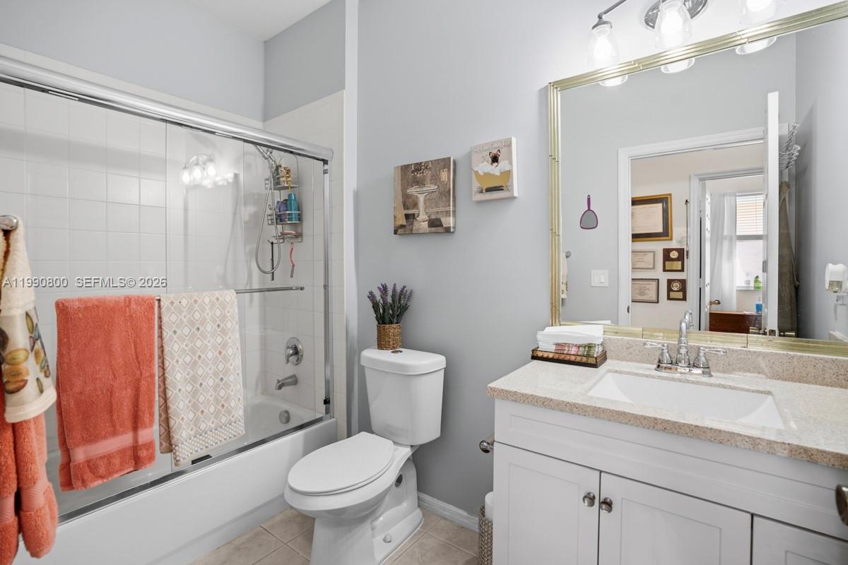 337 Southwest Maclay Way Port St. Lucie, FL 34986 - Photo 19 of 44 a bathroom with a toilet sink and shower