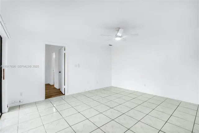 a bedroom with a bed and a potted plant