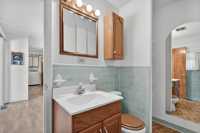 a bathroom with a sink toilet and mirror