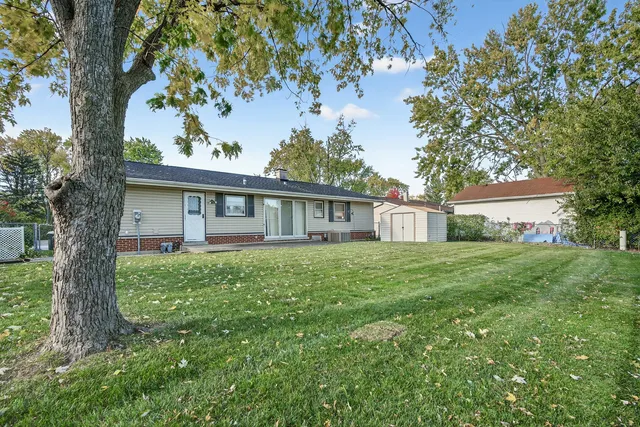 a view of a house with a backyard