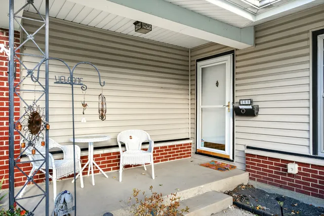 a backyard of a house with a table and chairs