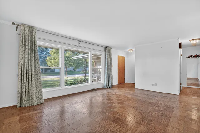 a view of empty room with floor to ceiling window