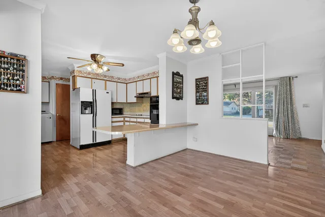 a living room with stainless steel appliances kitchen island granite countertop furniture and a kitchen view