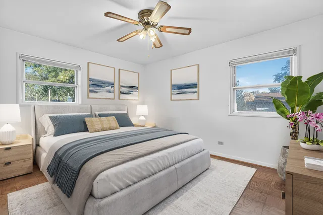 a bedroom with a large bed and a chandelier