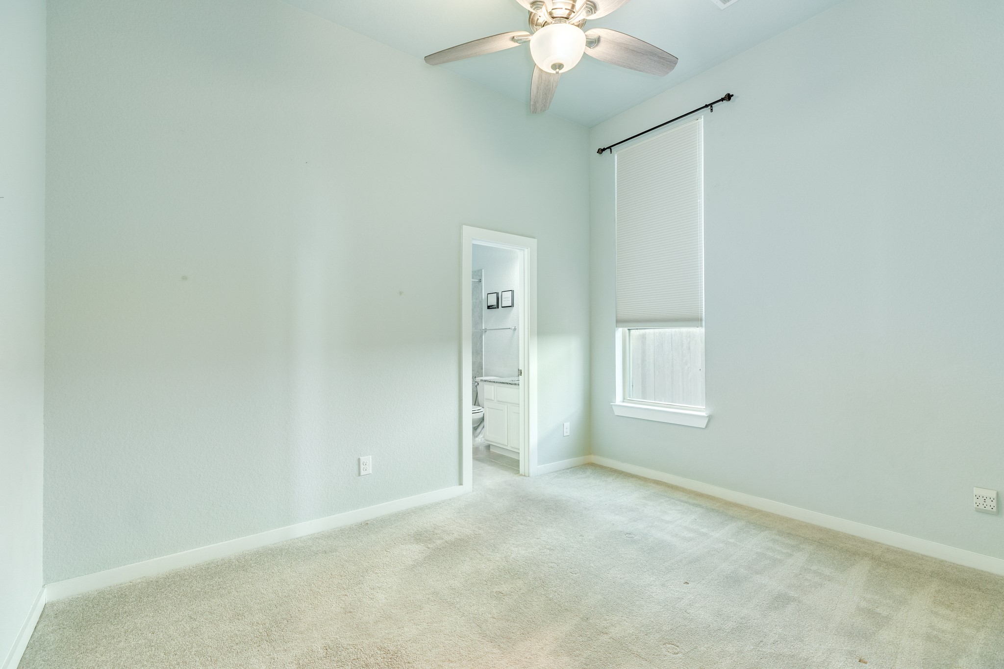 4015 Shackleton Court Iowa Colony, TX 77583 - Photo 22 of 50 Guest bedroom features a private ensuite bathroom, ideal for visitor comfort and privacy, and includes plush carpeting and a modern ceiling fan.