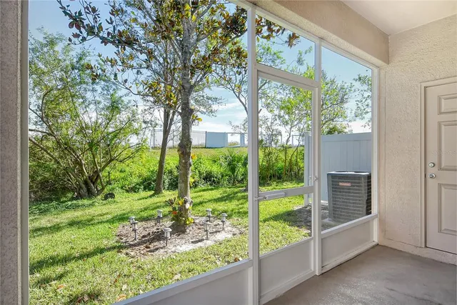a view of backyard with large trees and plants