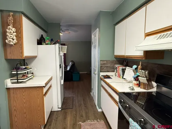 a white toilet sitting next to a shower curtain