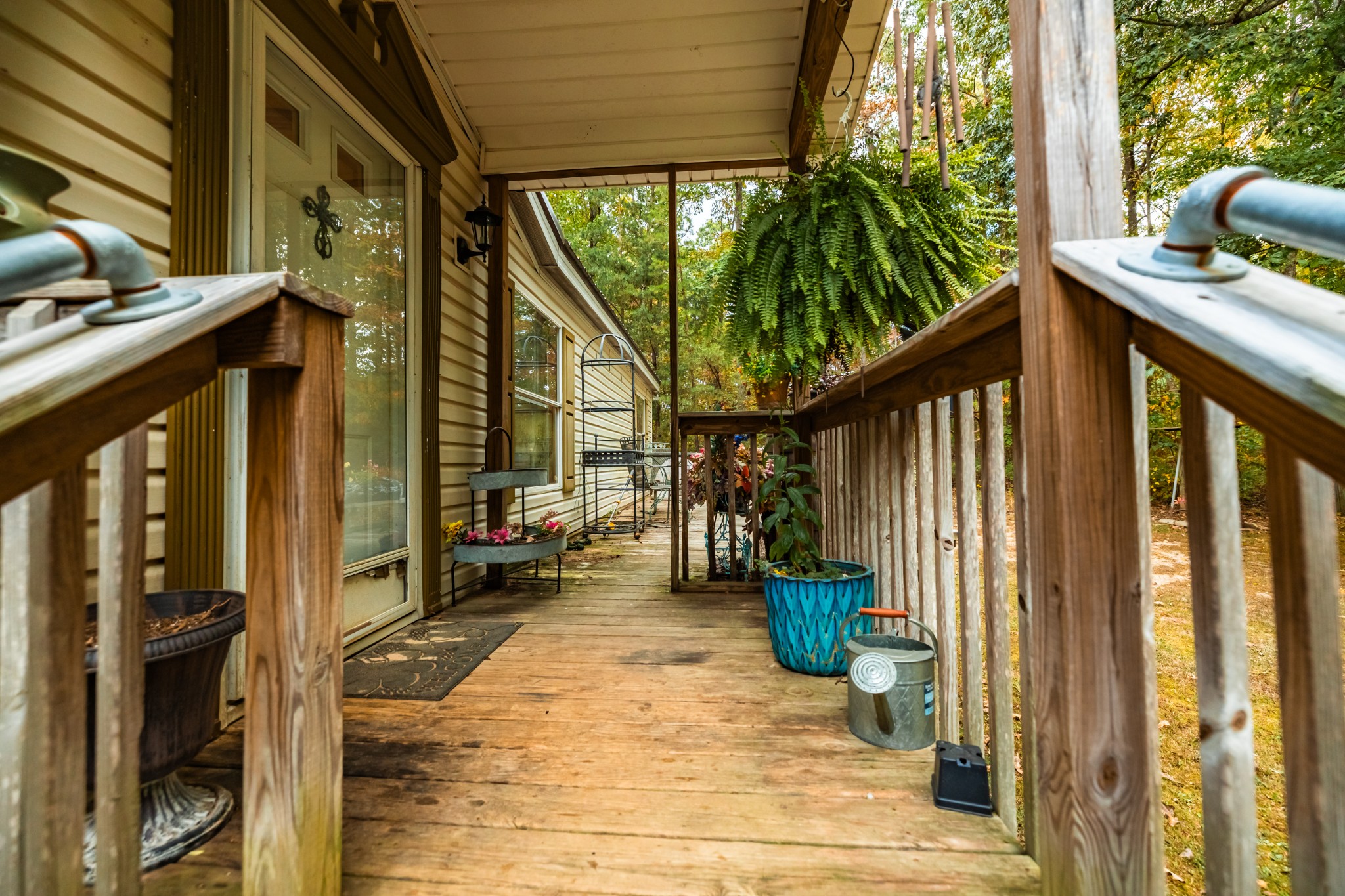 382 Locust Road Dunlap, TN 37327 - Photo 28 of 44 a view of a porch with couches potted plants and floor to ceiling window