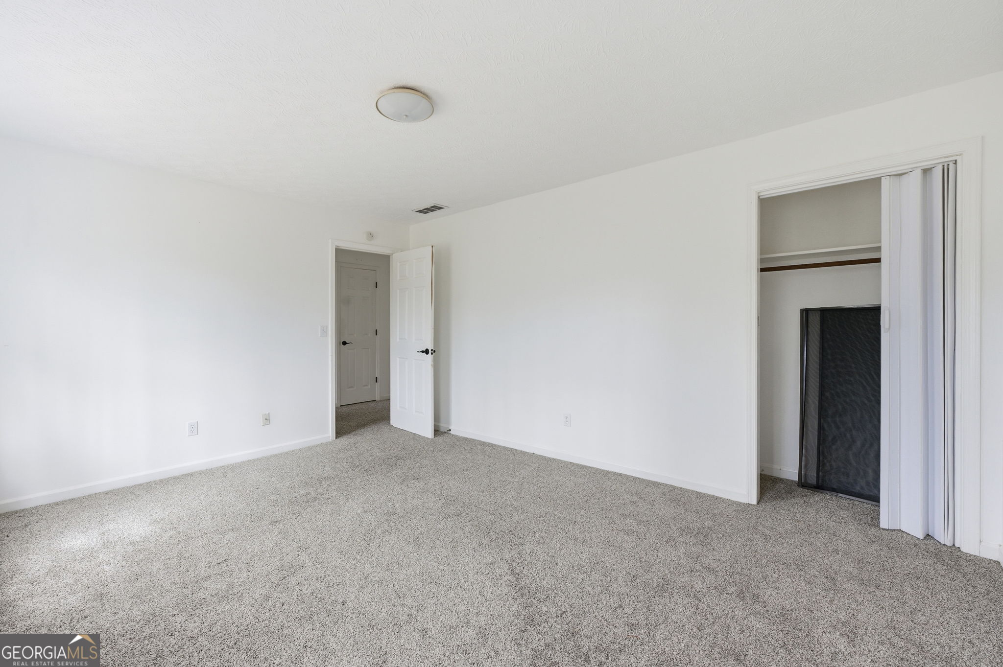 1732 Golfcrest Court Stone Mountain, GA 30088 - Photo 29 of 41 a view of an empty room with closet and a window