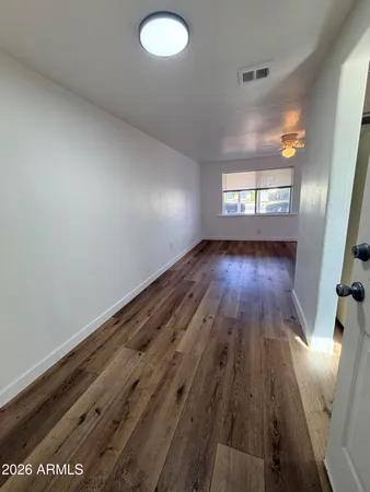 wooden floor in an empty room with windows