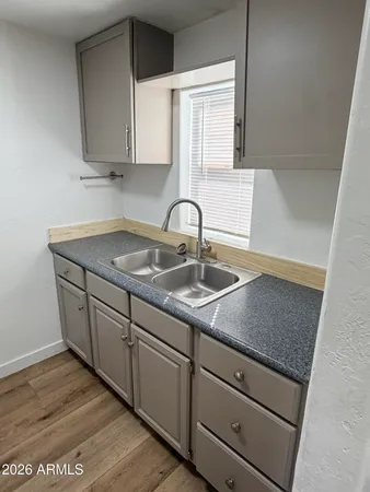 a kitchen with sink and cabinets