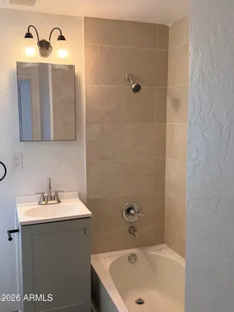 a bathroom with a sink a toilet and mirror