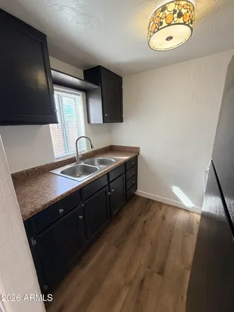 a kitchen with a sink a stove and a microwave