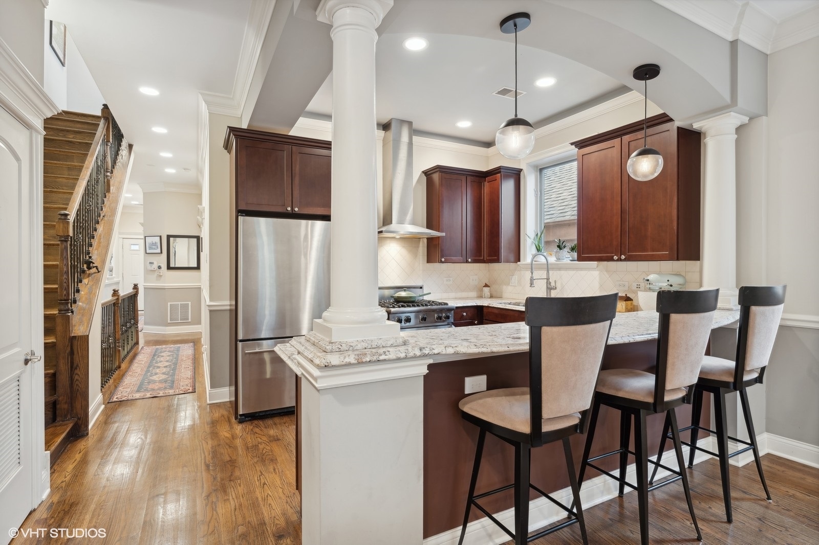 3232 North Seminary Avenue, Unit 3 Chicago, IL 60657 - Photo 6 of 22 a kitchen with stainless steel appliances granite countertop a stove a refrigerator a kitchen island a sink and chairs