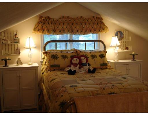 2 Nowers Road Lexington, MA 02420 - Photo 5 of 22 a bed sitting in a bedroom next to a window