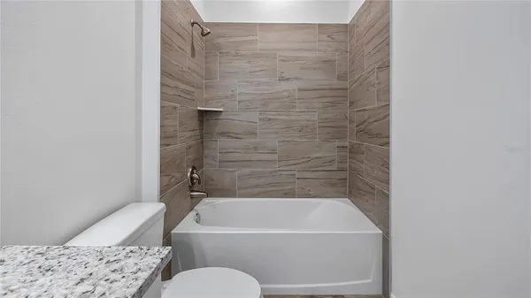 a bathroom with a bathtub and a toilet