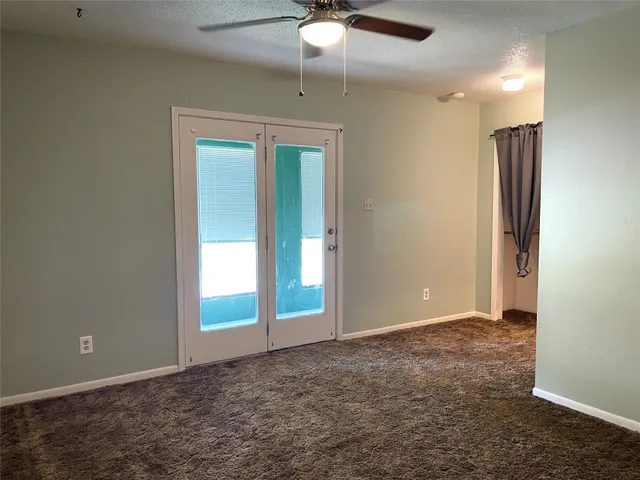 a view of hallway with large windows