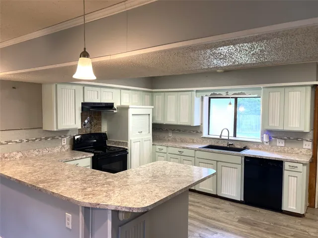 a kitchen with a sink stove and refrigerator