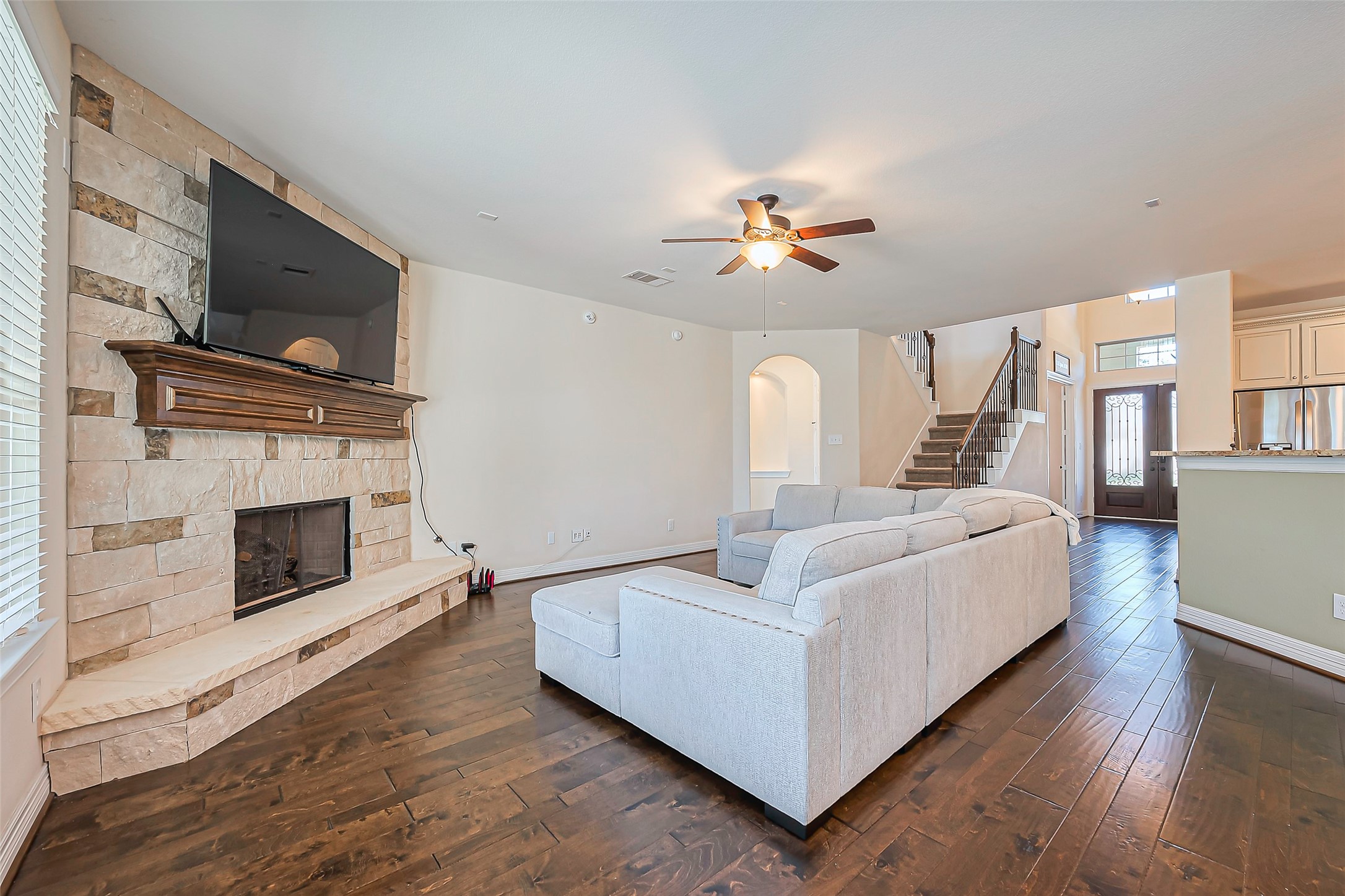 10018 Durango Path Lane Cypress, TX 77433 - Photo 14 of 50 Warm and inviting living area featuring a charming fireplace.