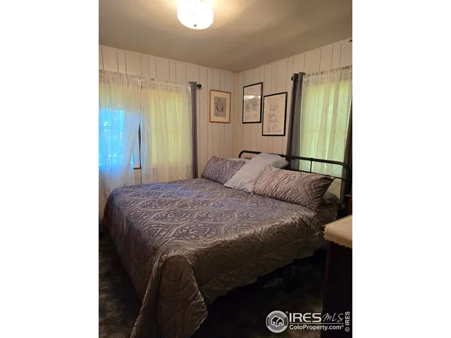 a bedroom with a bed and a mirror
