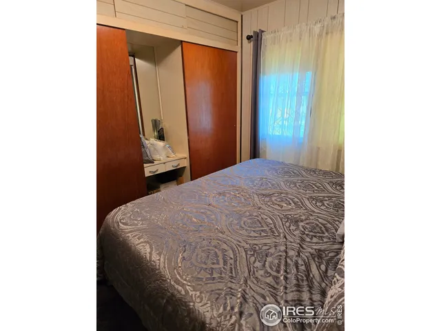 a bedroom with a bed and a mirror