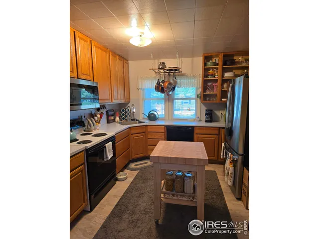 a kitchen with stainless steel appliances granite countertop a stove and a refrigerator