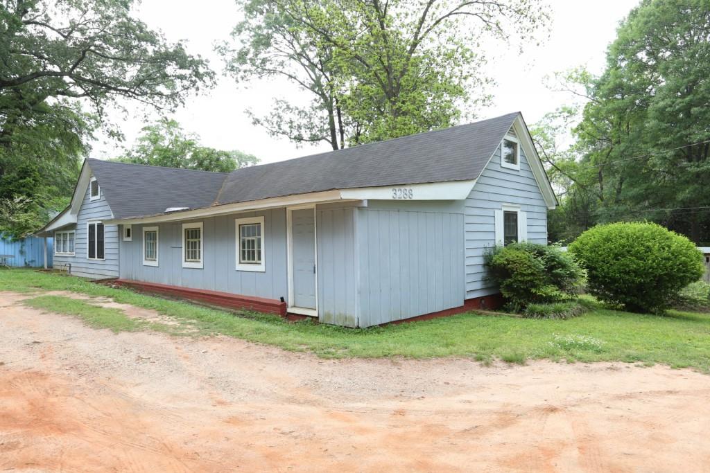 3288 Myrtle Street Hapeville, GA 30354 - Photo 1 of 1 a front view of a house with a garden and yard