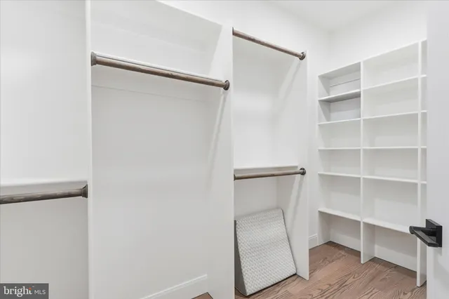 a view of walk in closet with empty racks