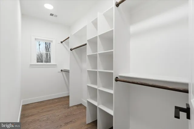 a bathroom with a double vanity sink a mirror and a bathtub