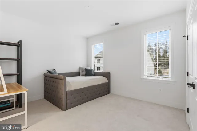 a bathroom with a sink vanity mirror and toilet