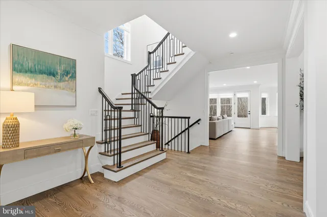 a view of entryway and hall with wooden floor