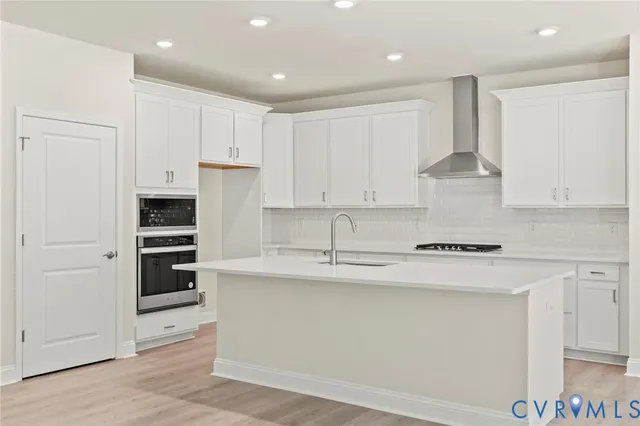 a kitchen with stainless steel appliances granite countertop a stove and a refrigerator