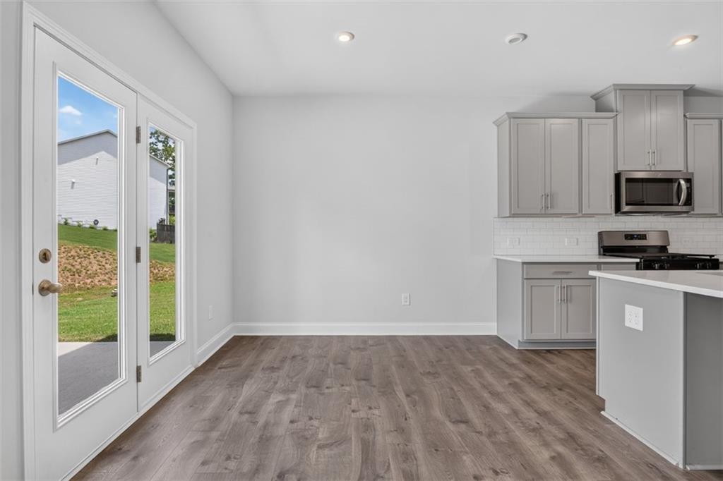 107 Ledgemont Way Acworth, GA 30101 - Photo 10 of 57 a kitchen with a hard wood floor window and a refrigerator