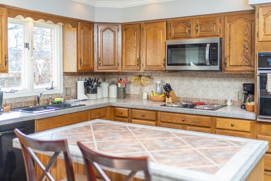 624 Augusta Farms Road Waynesboro, VA 22980 - Photo 16 of 63 a kitchen with stainless steel appliances granite countertop a sink and a microwave