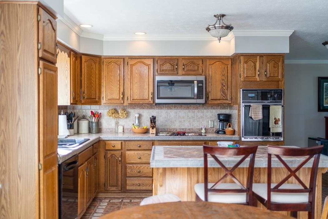 624 Augusta Farms Road Waynesboro, VA 22980 - Photo 18 of 63 a kitchen with stainless steel appliances granite countertop a stove top oven a sink dishwasher and white cabinets with wooden floor