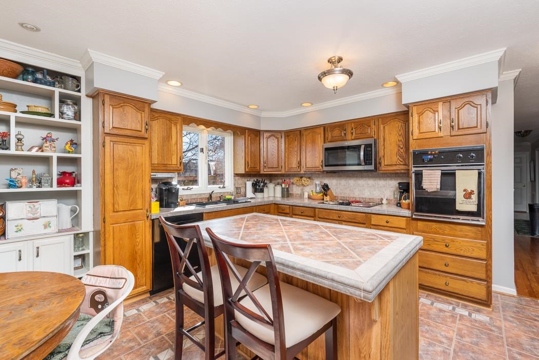 624 Augusta Farms Road Waynesboro, VA 22980 - Photo 25 of 63 a kitchen with stainless steel appliances granite countertop a stove top oven a sink dishwasher and a refrigerator with wooden floor