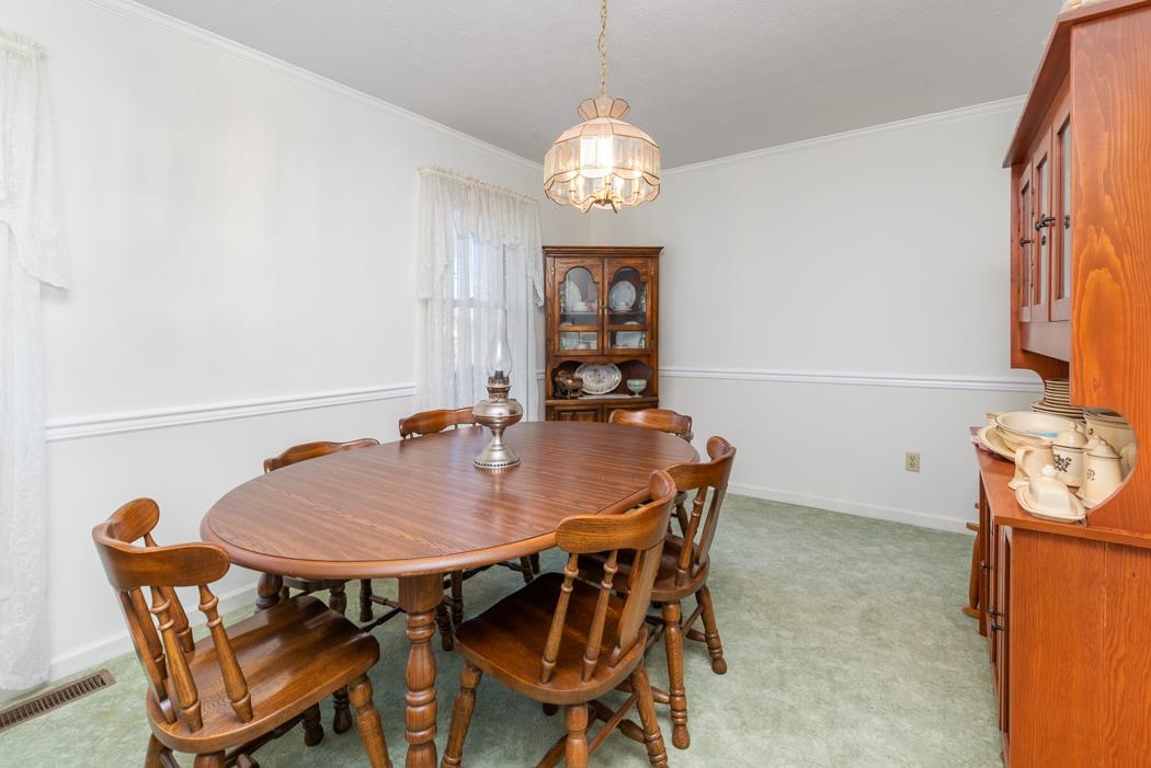 624 Augusta Farms Road Waynesboro, VA 22980 - Photo 27 of 63 a view of a dining room with furniture and chandelier