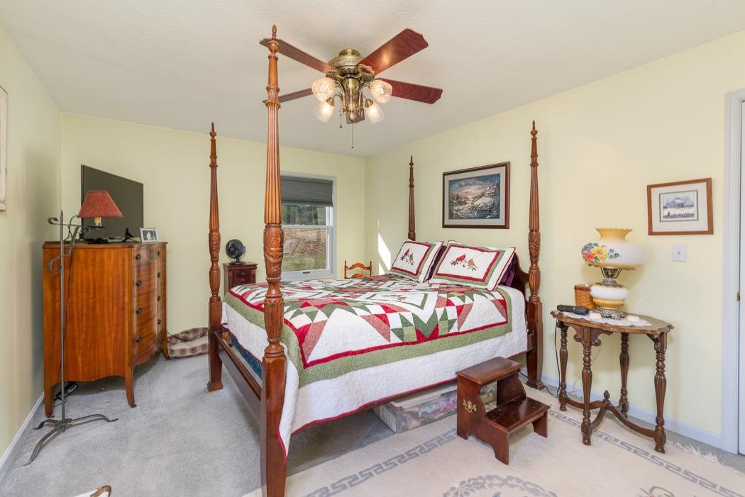 624 Augusta Farms Road Waynesboro, VA 22980 - Photo 31 of 63 a bedroom with a bed and a table in it