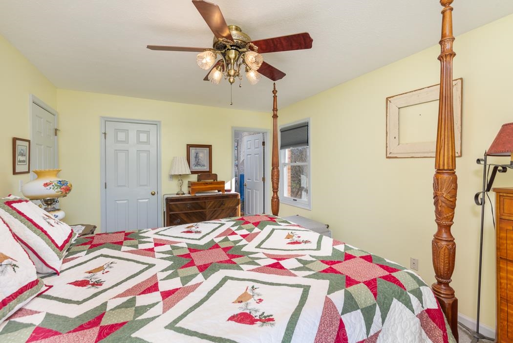 624 Augusta Farms Road Waynesboro, VA 22980 - Photo 32 of 63 a bedroom with a bed and a chandelier